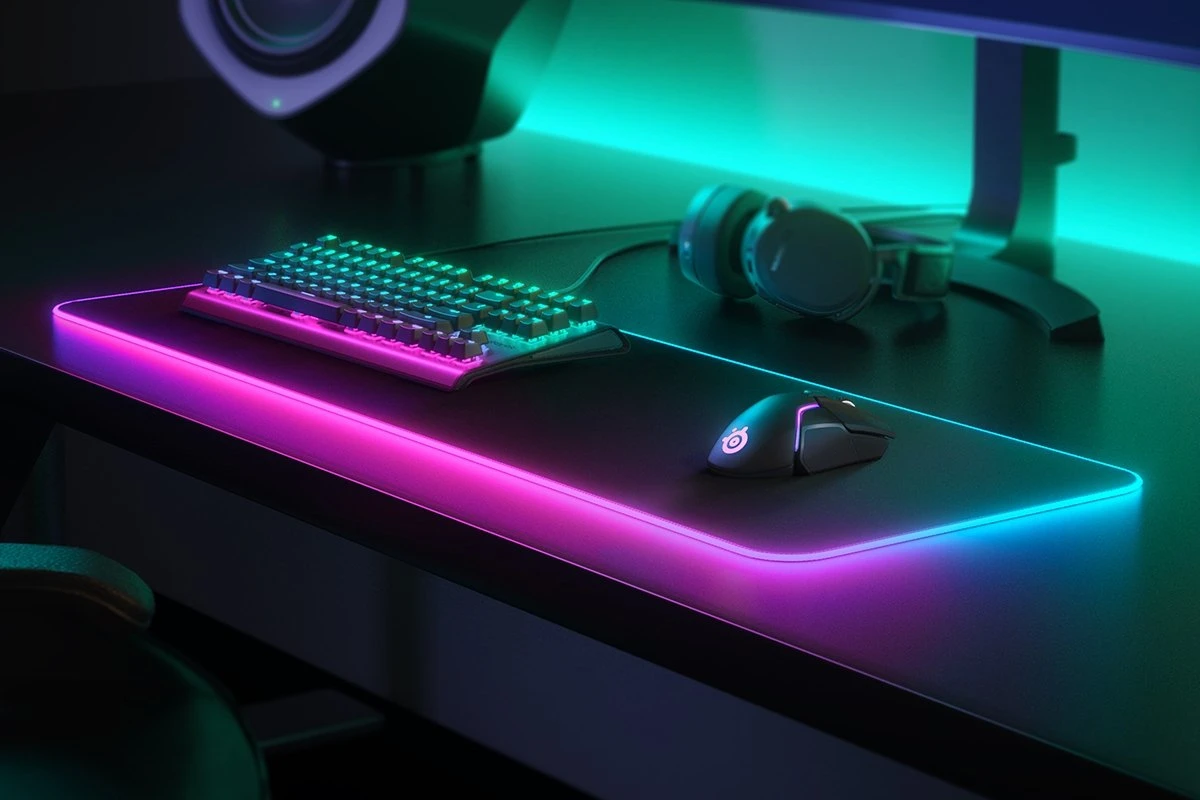 keyboard, mouse, mousepad and headset surrounded by colorful neon lights