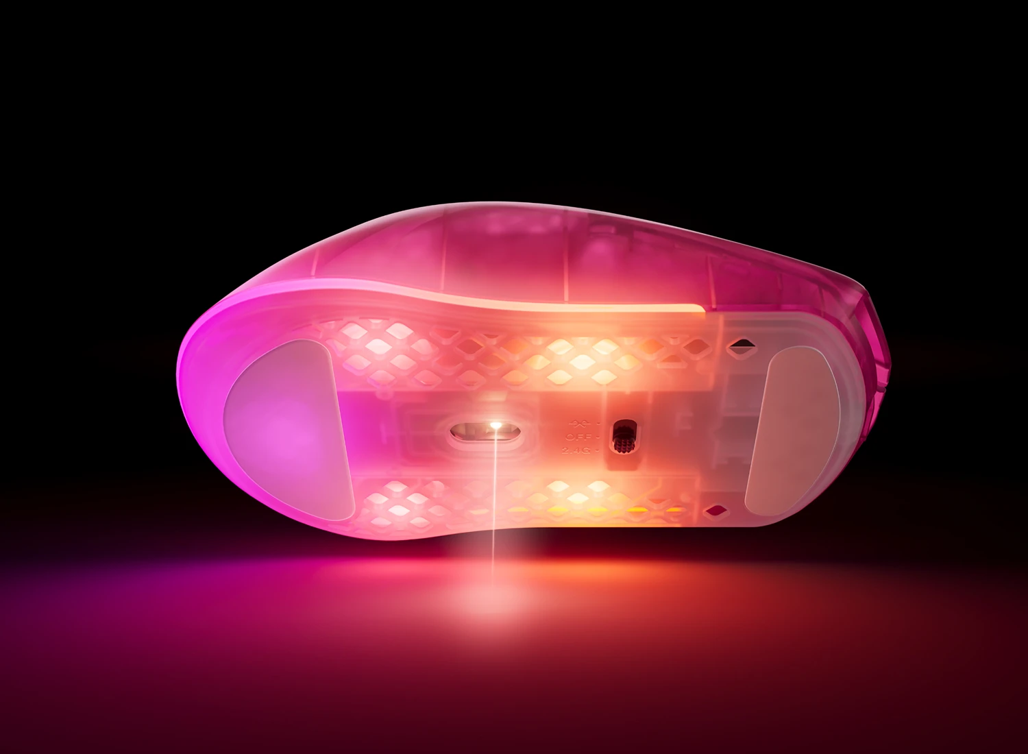 Bottom of RGB mouse emitting laser beam onto surface in pink and blue lighting.