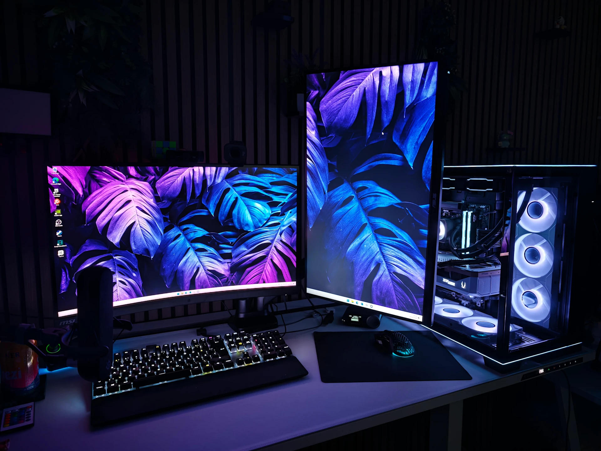 a gaming setup with dual screen and Black PC with White RGB and transparent windows featuring SteelSeries Gear