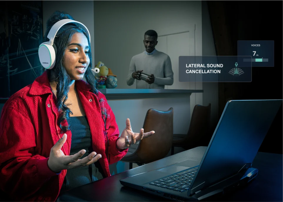 Woman chatting in front of her computer with someone playing in the background. Nahimic Lateral Sound Cancellation feature UI is displayed.