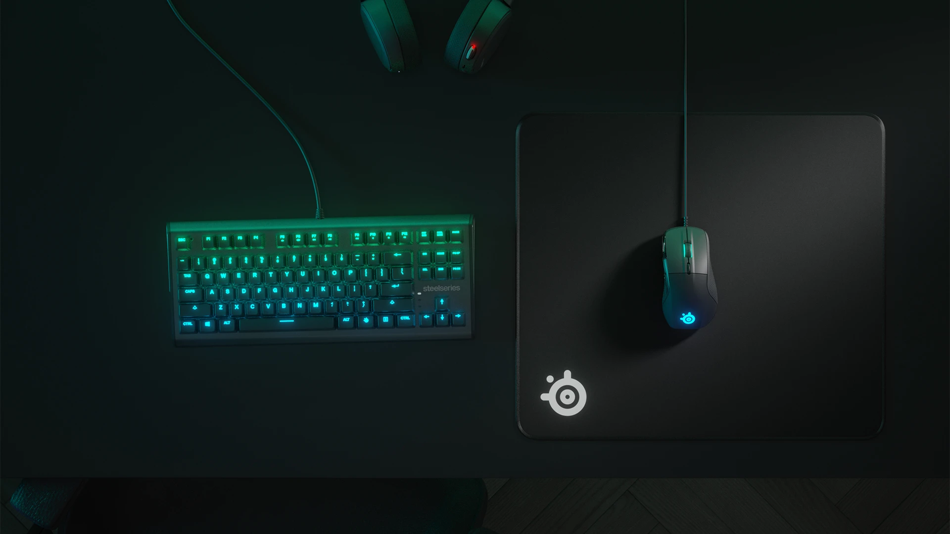 Top view of an RGB keyboard and QcK Edge mousepad with a mouse; everything in shades of green