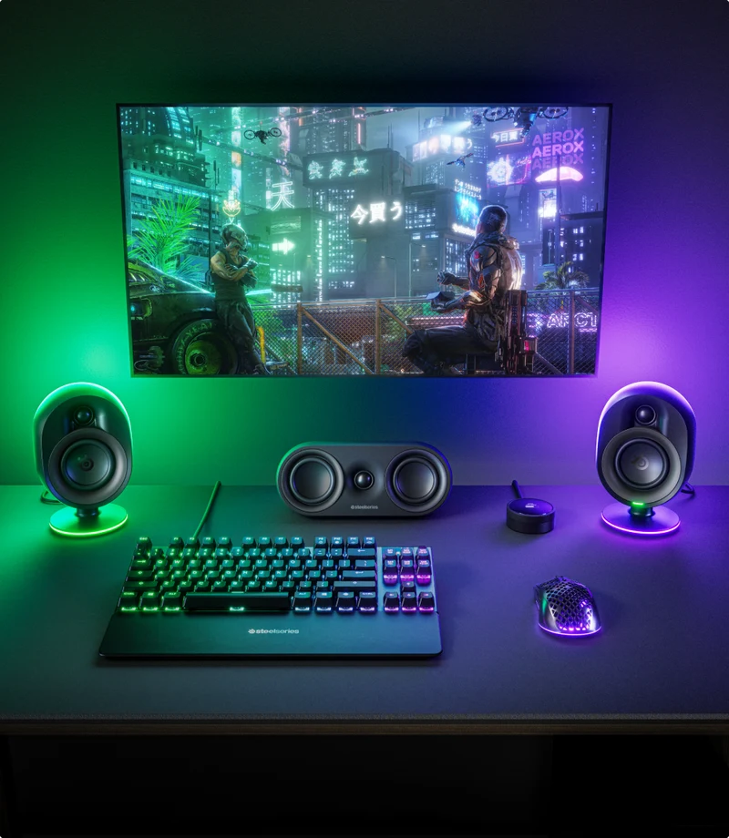 Gaming setup surrounded by green and purple lights.