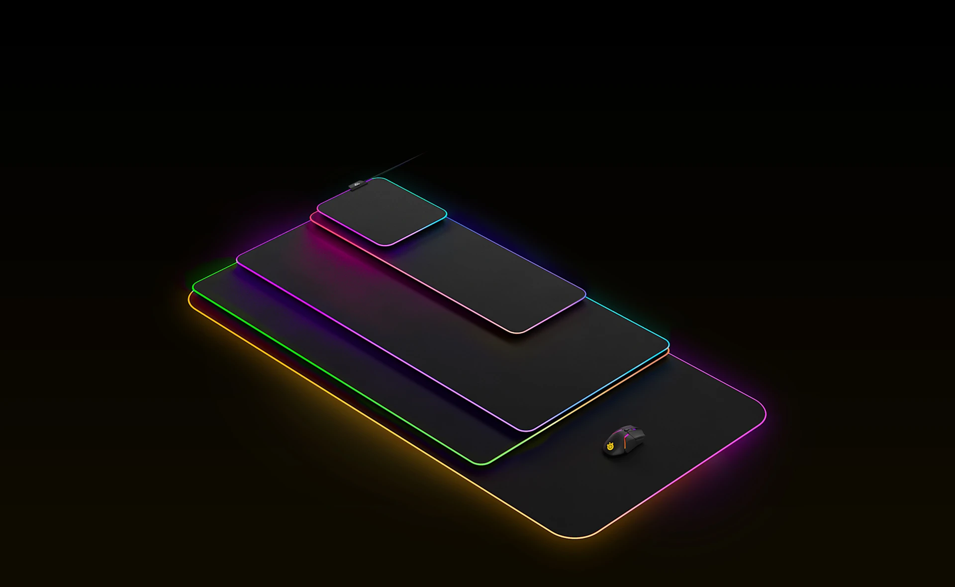 Tüm renkli SteelSeries Prism mousepad'ler RGB renkleriyle aydınlatılmış şekilde üst üste dizilmiştir.