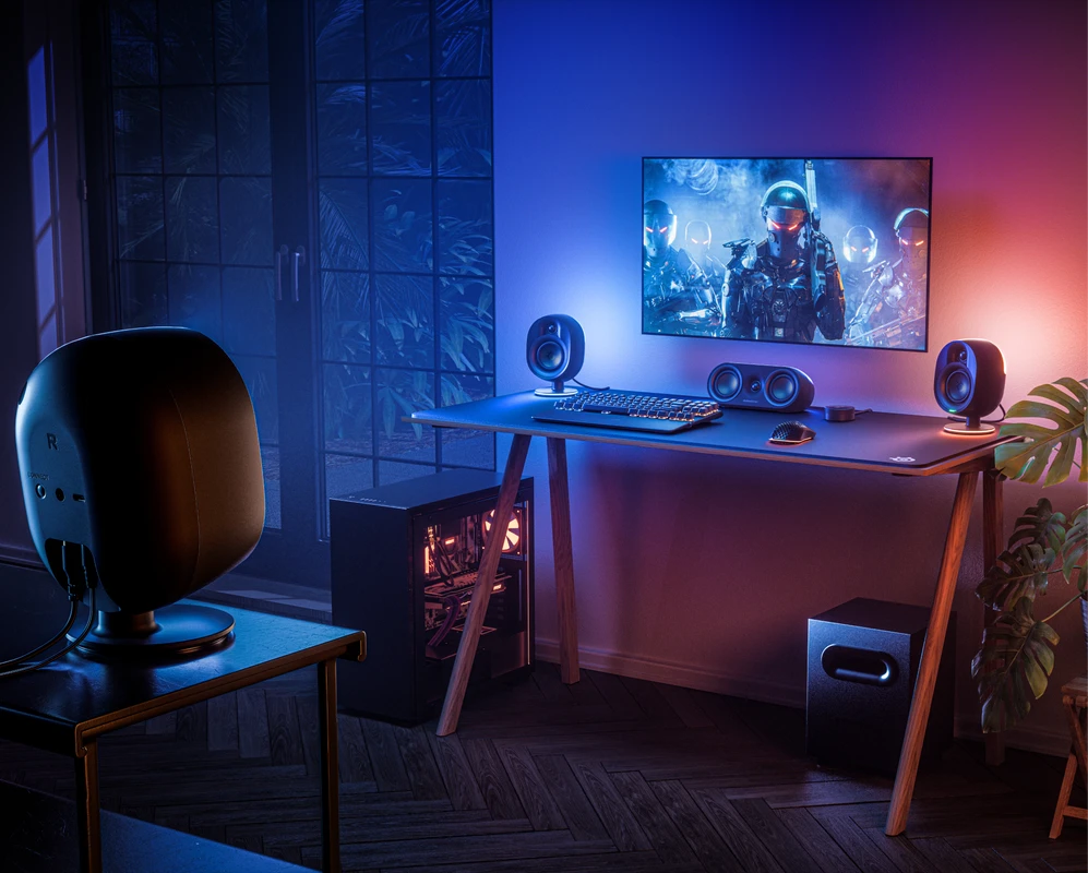 gaming setup in a room illuminated by colorful lights