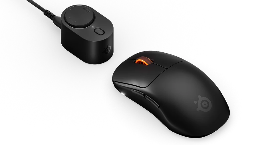 SteelSeries Sensei Pro gaming mouse on a gaming desk beside a keyboard and headset.