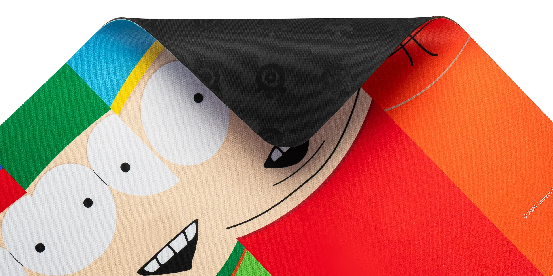 Close-up of the SteelSeries South Park 4 Boys cloth gaming mousepad with a corner folded back, showing the textured non-slip rubber base pattern over the colorful character graphics.