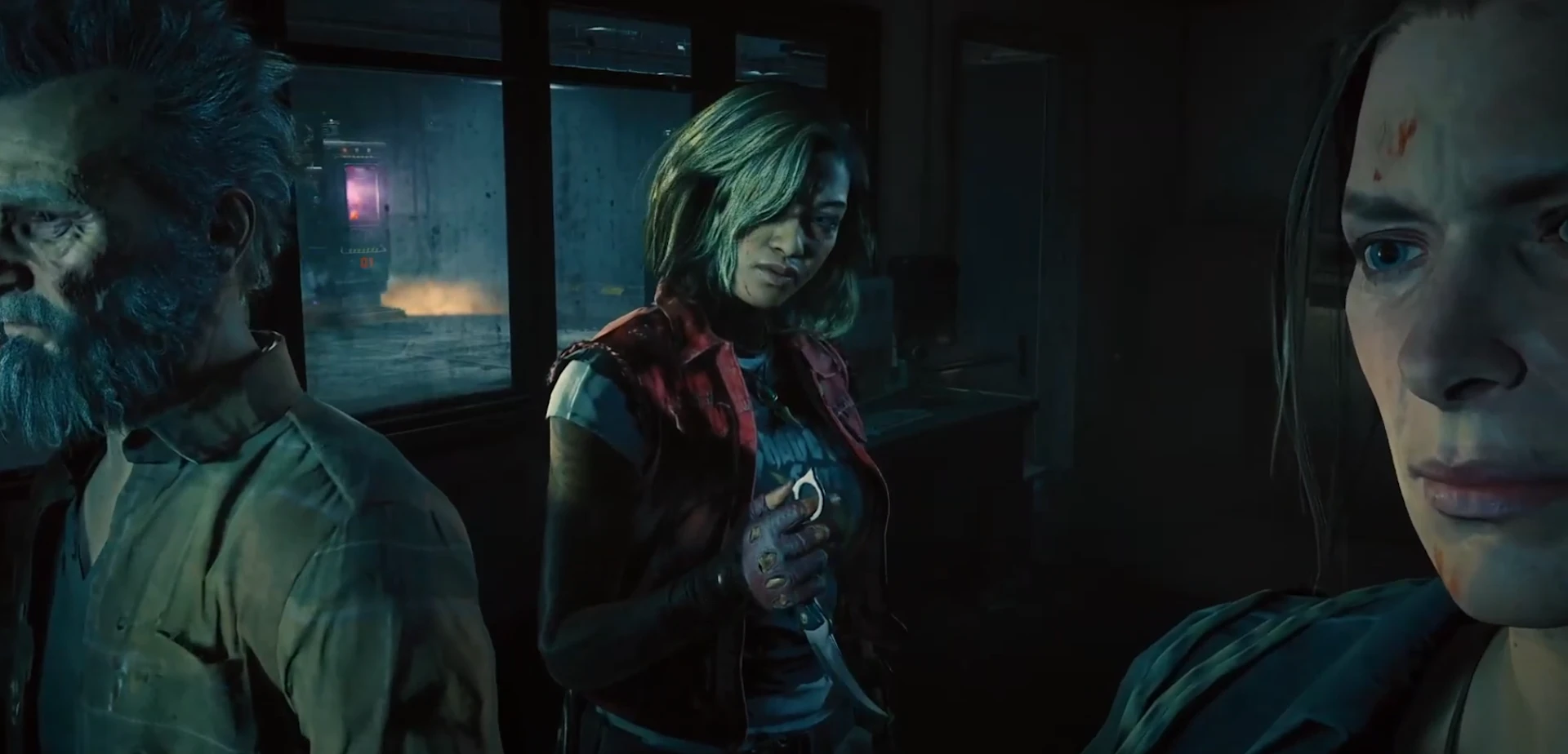 3 characters standing in the dark room, in the middle a woman handling a carrabit knife.