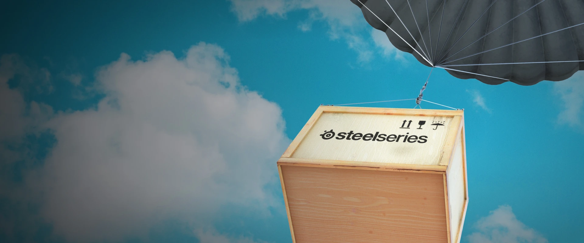 A SteelSeries loot box descending from the sky with a parachute.