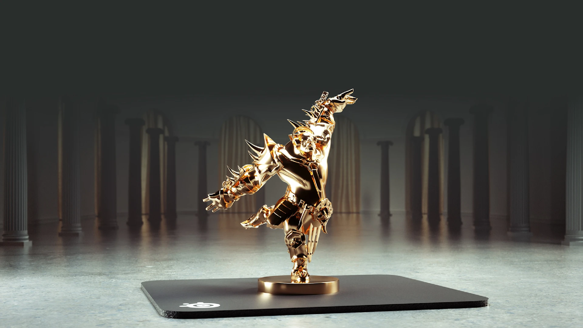 A golden ogre figurine by SteelSeries, standing on a QcK mousepad