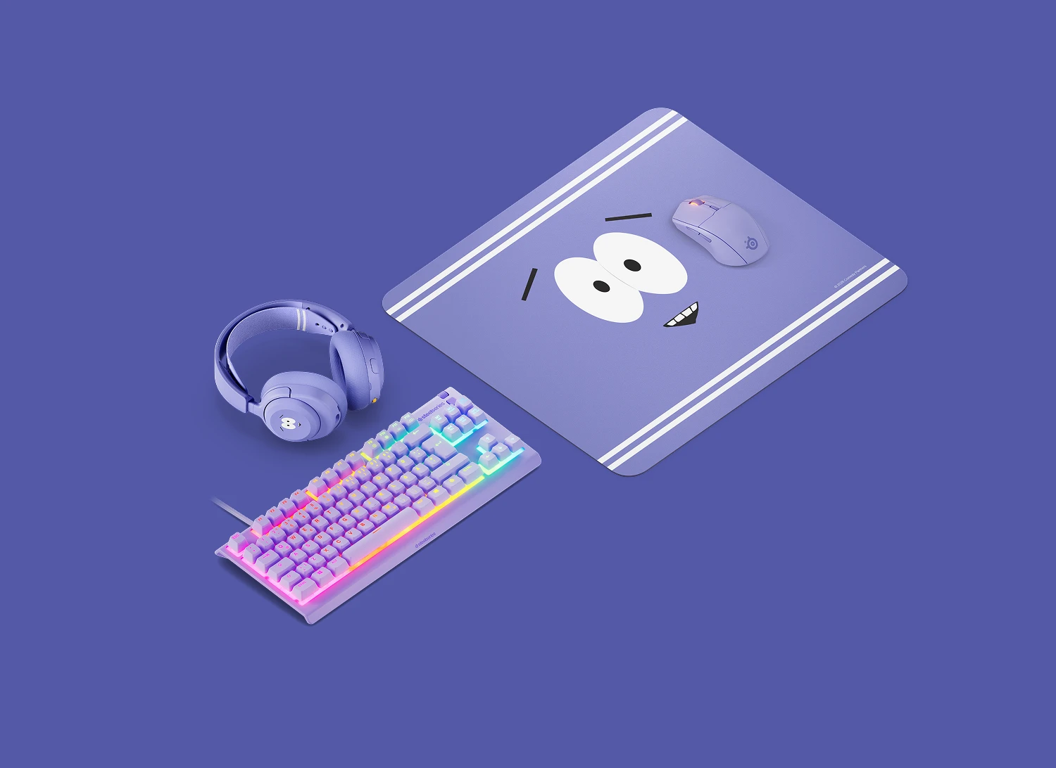 SteelSeries Towelie edition purple gaming gear setup including a large cloth mousepad, matching wireless gaming mouse, Arctis Nova headset, and an illuminated RGB mechanical keyboard.