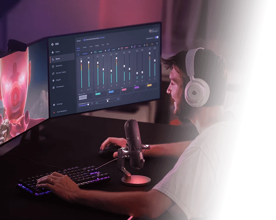  A man with a beard and headphones smiles while using SteelSeries Sonar audio software on his gaming computer.