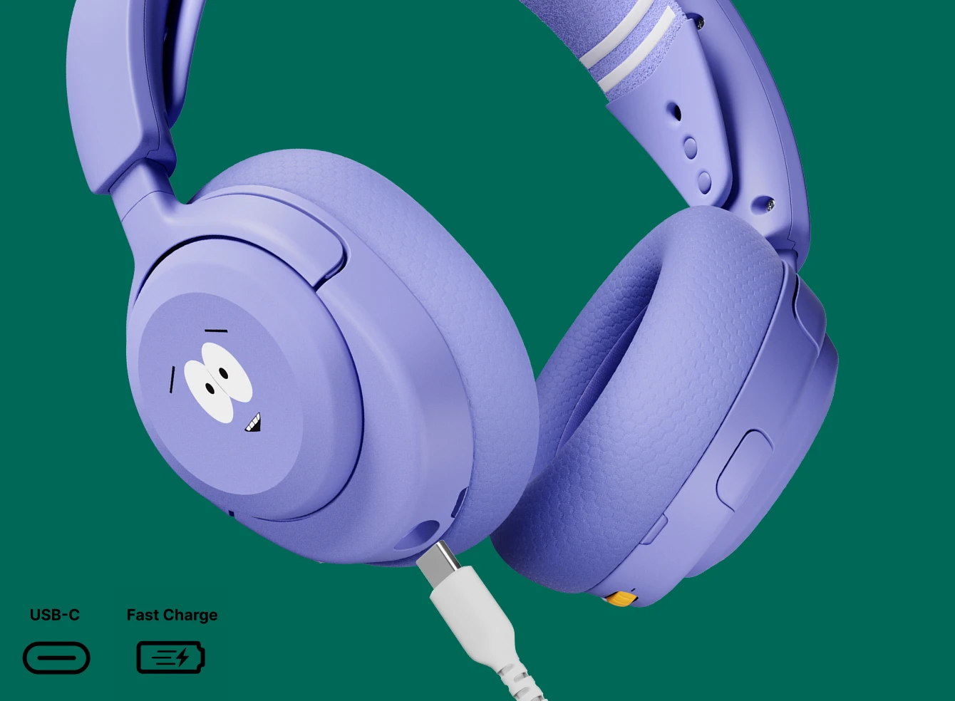 Close-up of the SteelSeries Arctis Nova 5 Wireless South Park edition gaming headset in purple, showing a Towelie on the ear cup with a white USB-C fast charging cable connected against a green background.