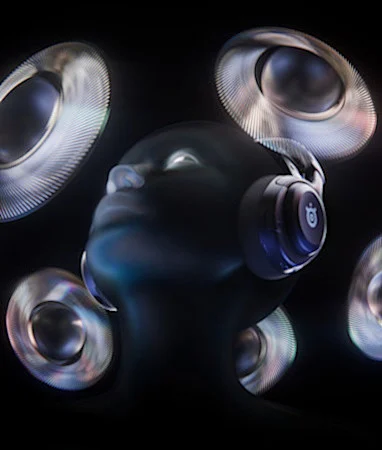 A head of a black mannequin wearing black Arctis Nova 5, surrounded by multiple floating speakers.