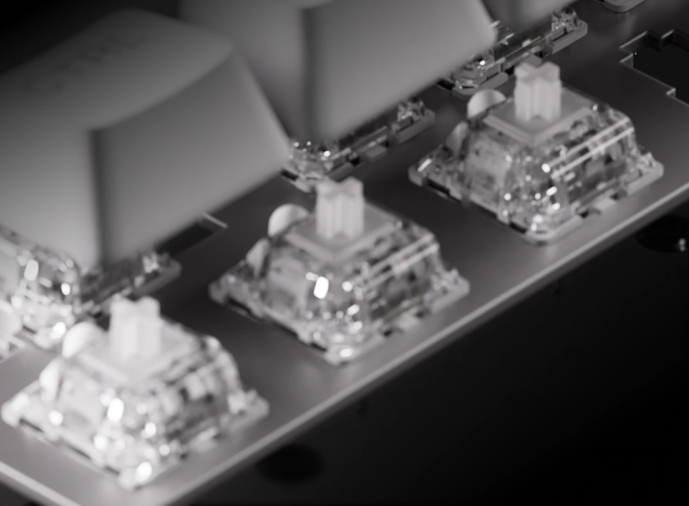 Macro view of clear OmniPoint adjustable mechanical switches on the Apex Pro Gen 3 keyboard.