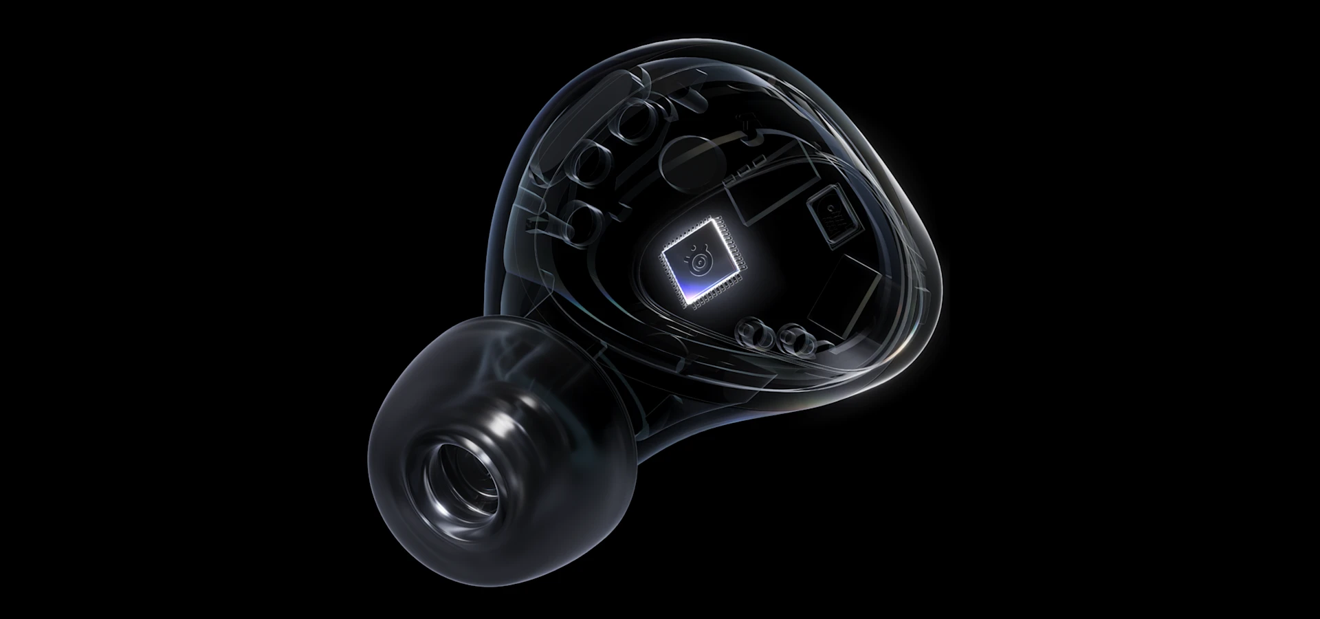 Unos audífonos transparentes, arctis Gamebud, con un pequeño chipset iluminado visible en el centro de los audífonos.
