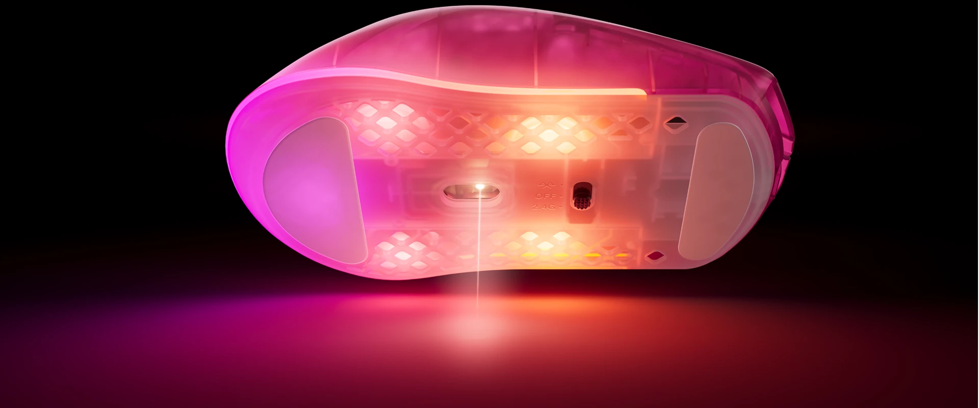 Bottom of RGB mouse emitting laser beam onto surface in pink and blue lighting.
