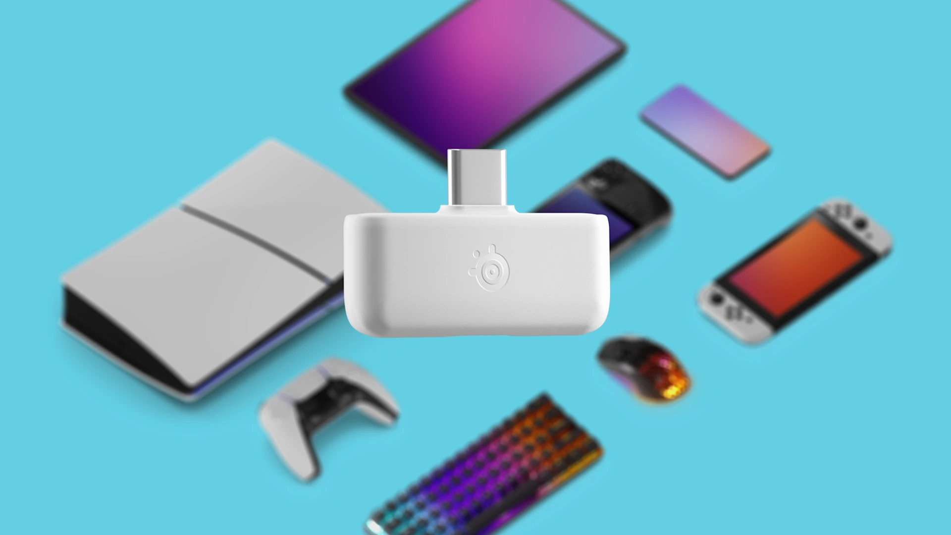 White SteelSeries USB-C wireless dongle centered over blurred multiplatform gaming devices including a PlayStation 5 console, Nintendo Switch, controller, keyboard, and smartphone.