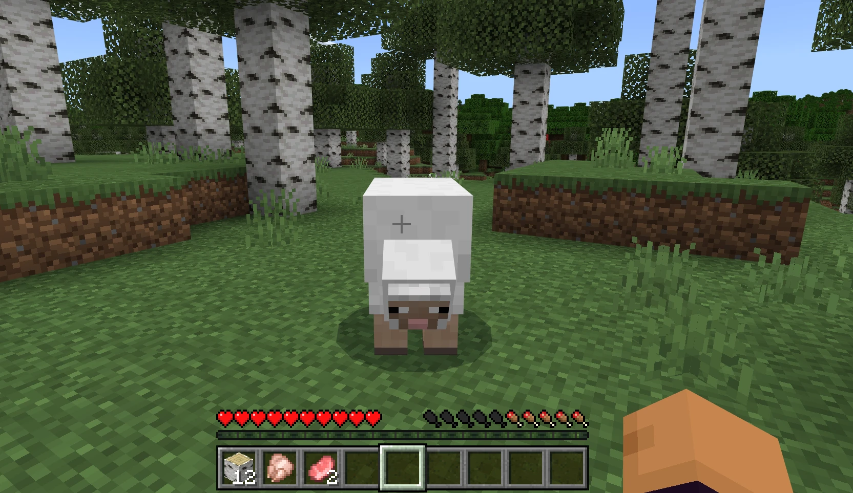 Sheep standing in between trees. 