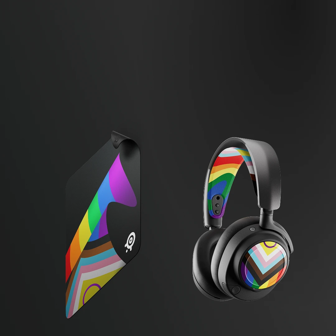 SteelSeries QcK cloth gaming mouse pad and wireless headset from the 2026 Pride collection with rainbow flag details.