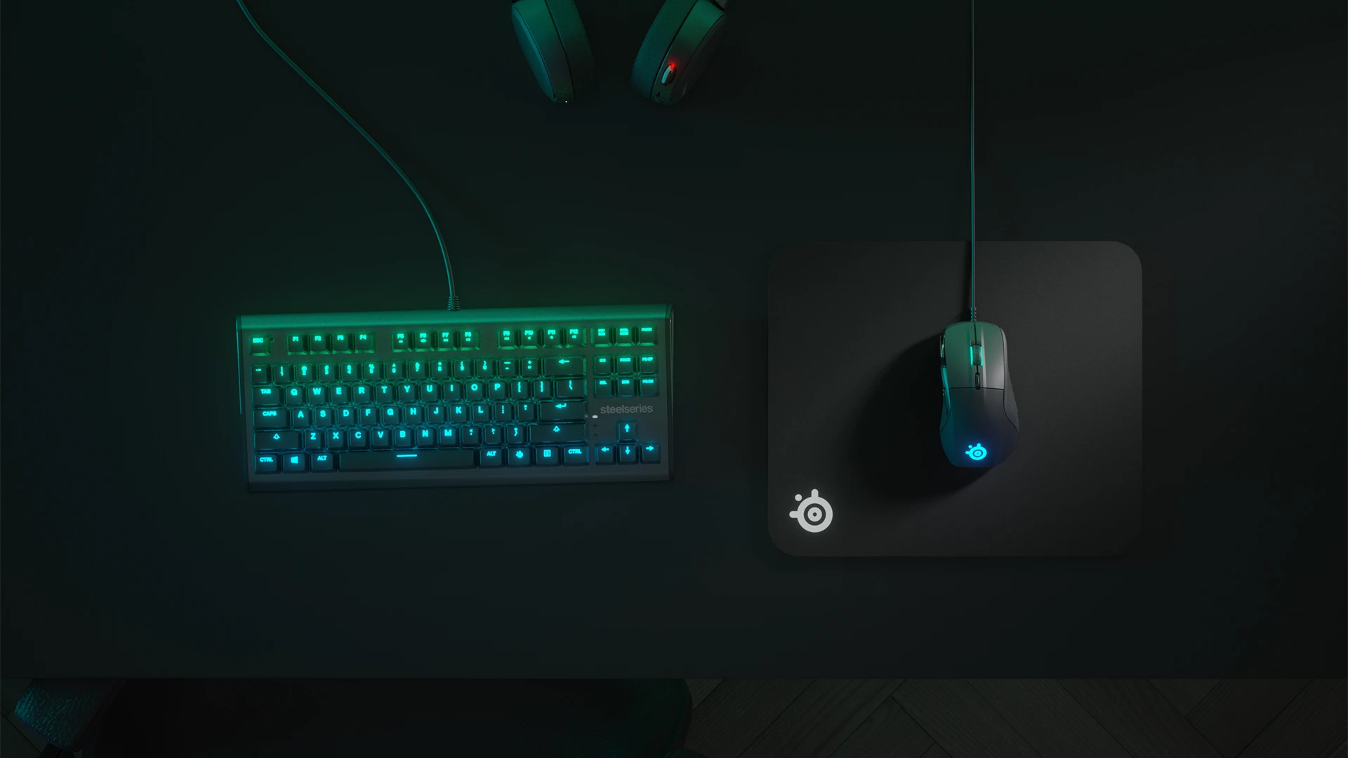 Top view of an RGB keyboard and QcK Heavy mousepad with a mouse; everything in shades of green