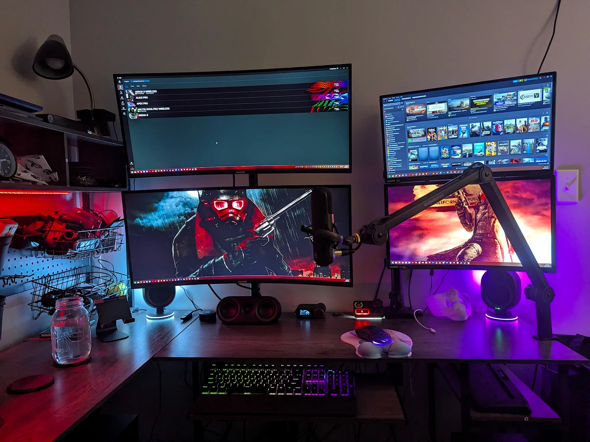 A high-tech gaming setup, bathed in multiple RGB lights, with a SteelSeries software menu on the monitor, and matching backlit peripherals on a dark desk.