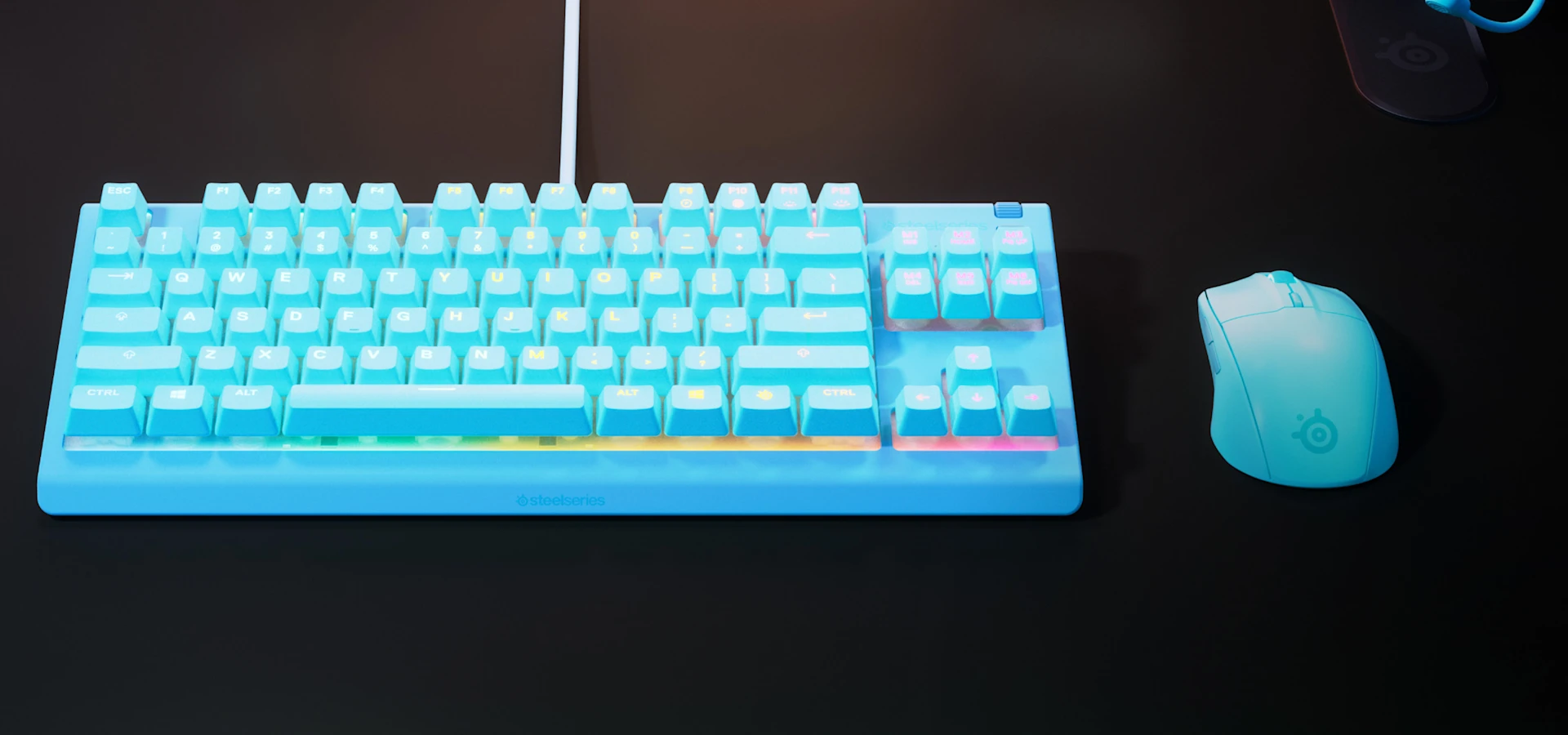 Apex 3 TKL keyboard on a desk together with gaming mouse