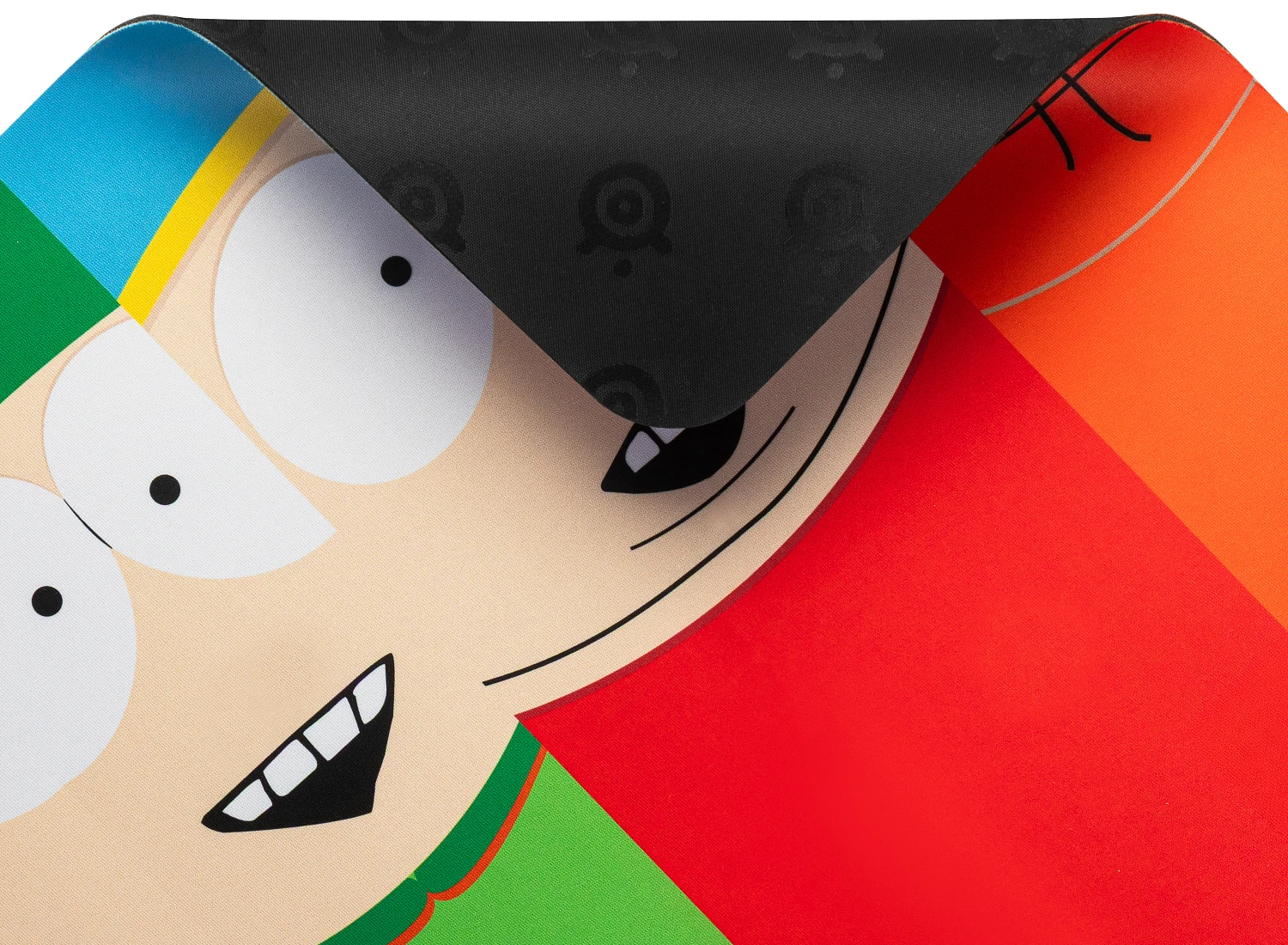 Close-up of the SteelSeries South Park 4 Boys cloth gaming mousepad with a corner folded back, showing the textured non-slip rubber base pattern over the colorful character graphics.