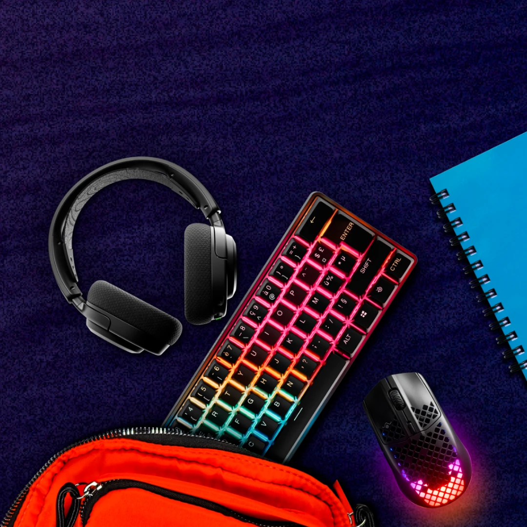 An image of assorted SteelSeries gear pictured with a backpack and notebook.