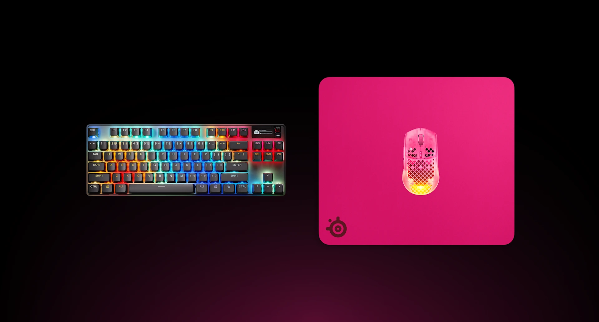 Ovenfra-billede af en magenta SteelSeries QcK Heavy XXL gaming-musemåtte med et RGB-mekanisk tastatur og en magenta Aerox gaming-mus.