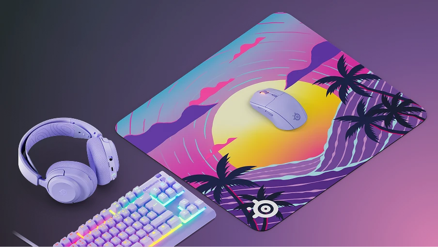SteelSeries QcK Neon Sunset mousepad on gaming desk with matching purple headset, mouse, and RGB keyboard.