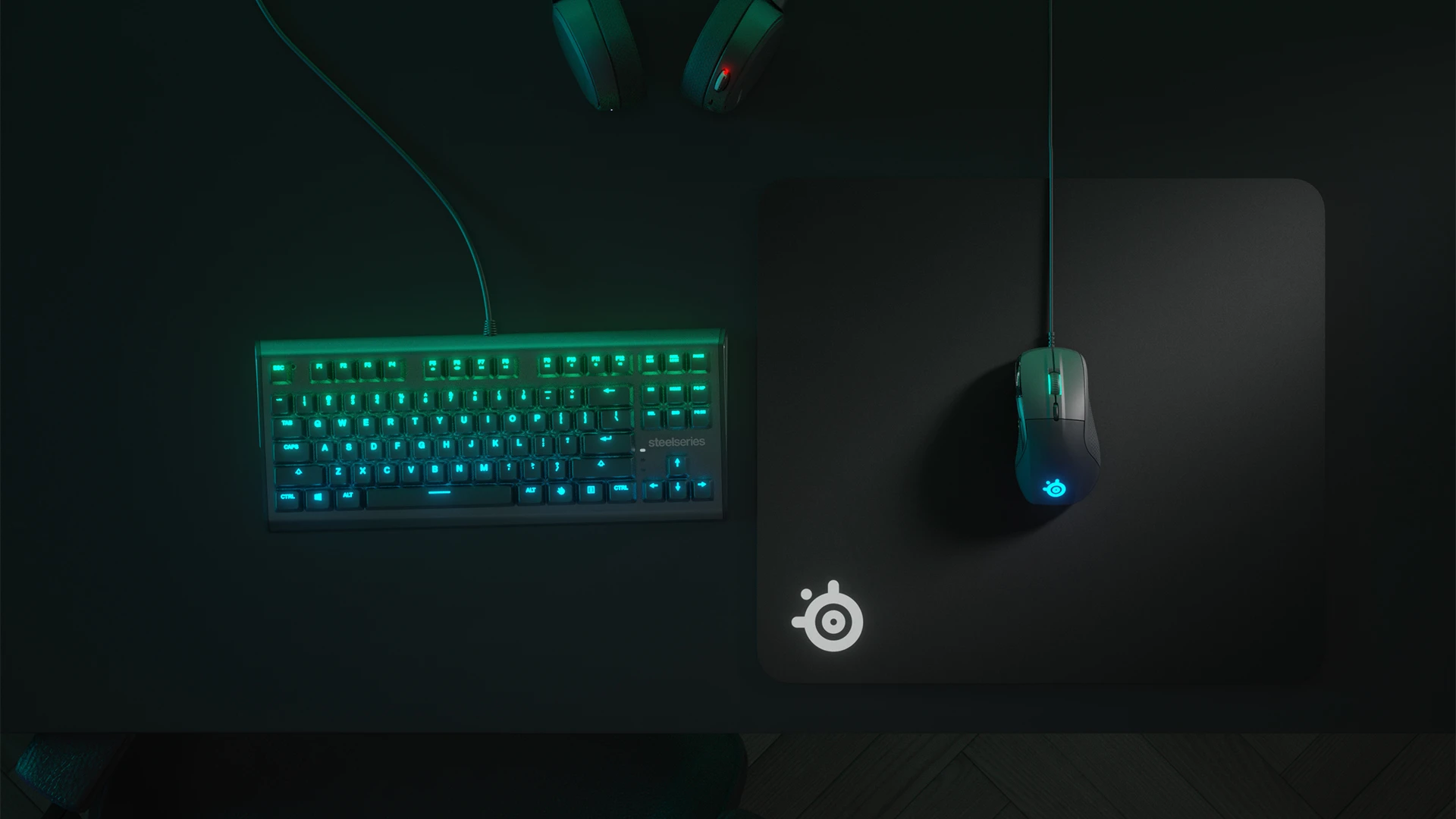 Top view of an RGB keyboard and QcK Heavy mousepad with a mouse; everything in shades of green