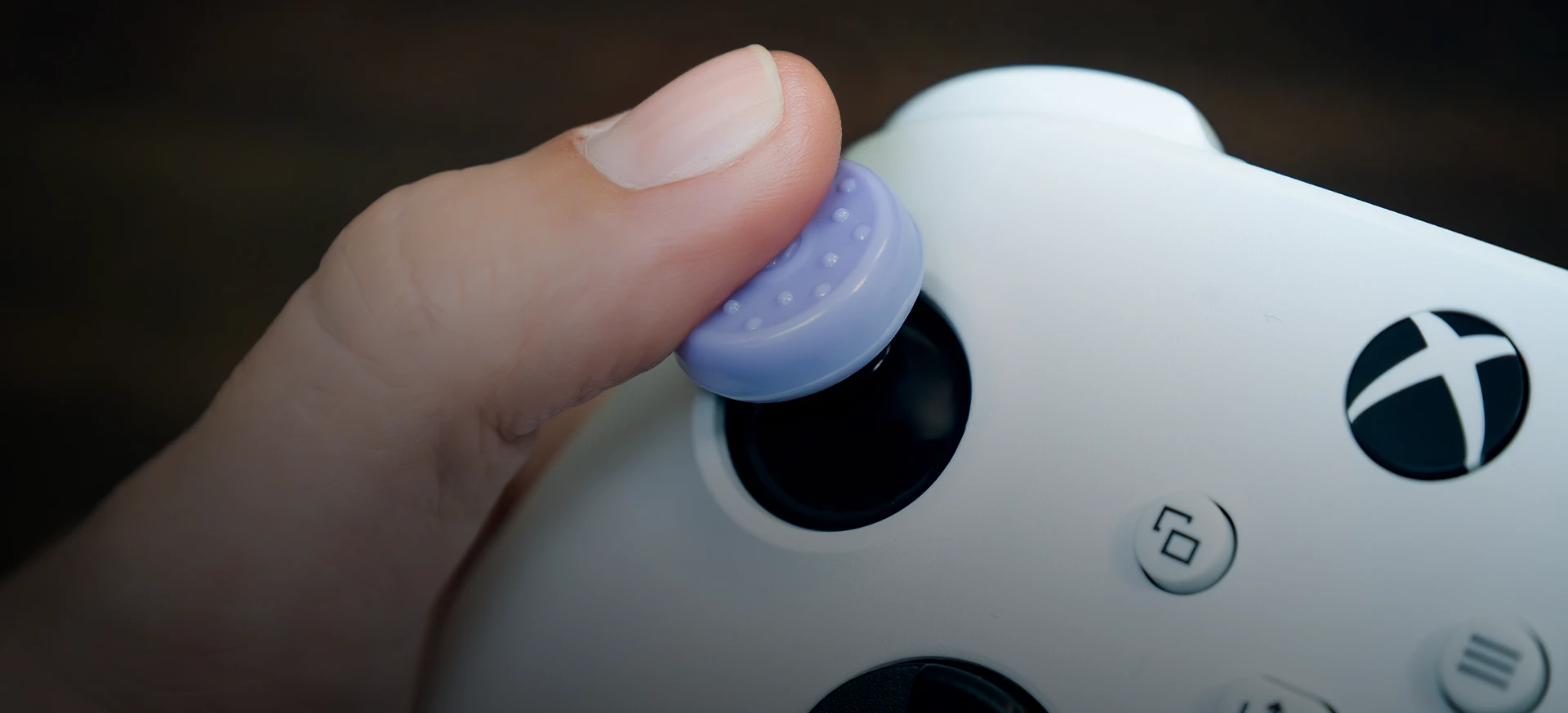Close-up view of a thumb moving the thumbstick.