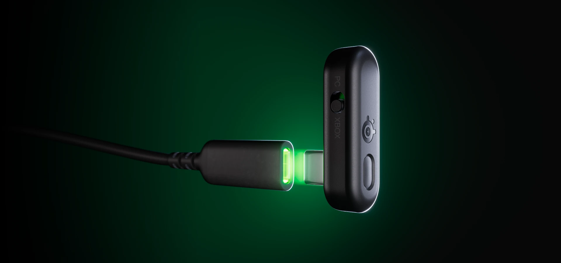 The Arctis Gamebuds dongle slowly reaches the USB-C port; the space between them lights up green.