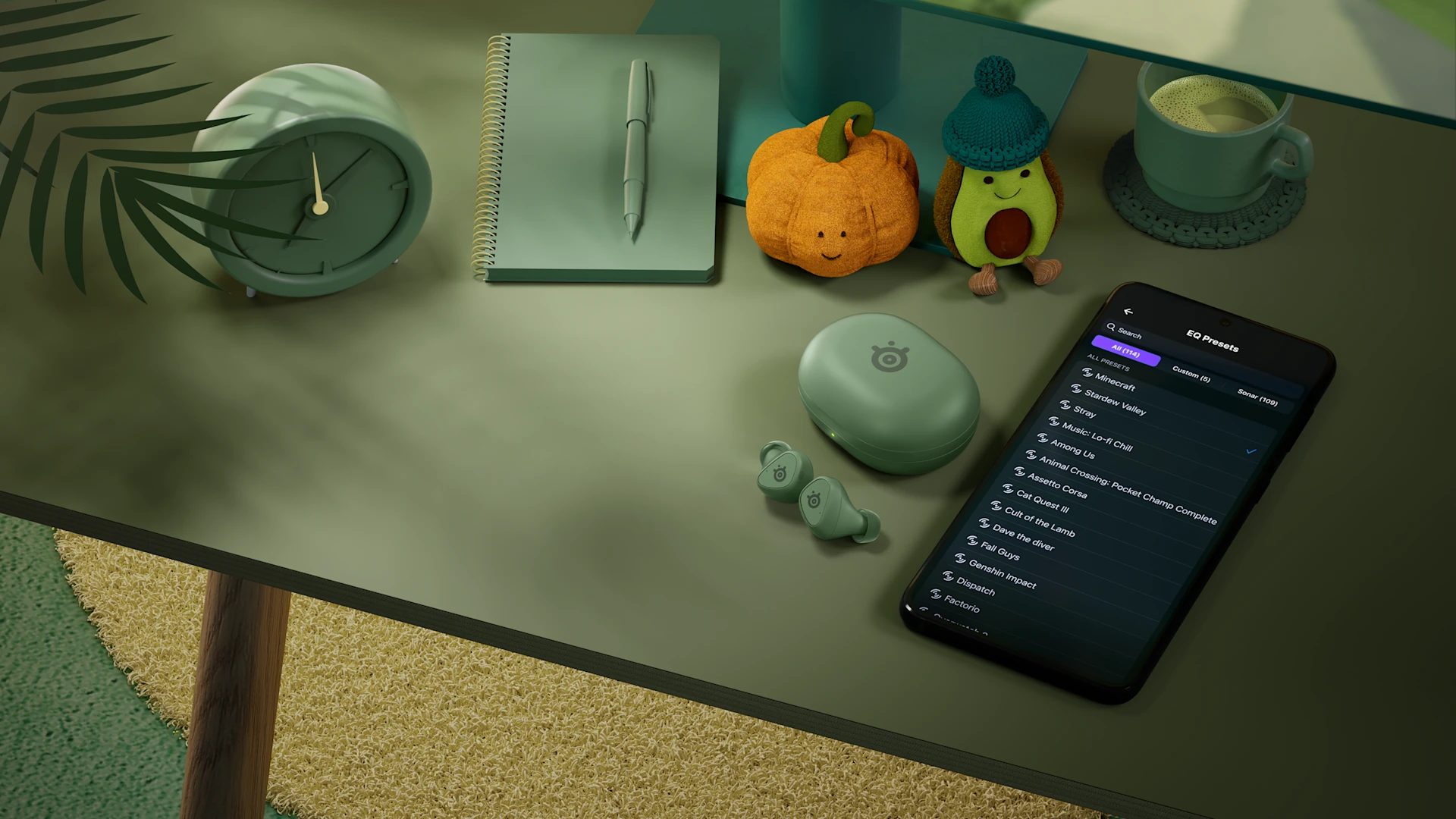 SteelSeries Arctis GameBuds in matcha green on a desk alongside a mobile phone displaying companion audio app settings.