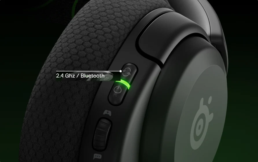 A view of a single Arctis Nova 5 headphone with visible side buttons for Bluetooth and 2.4Ghz options.