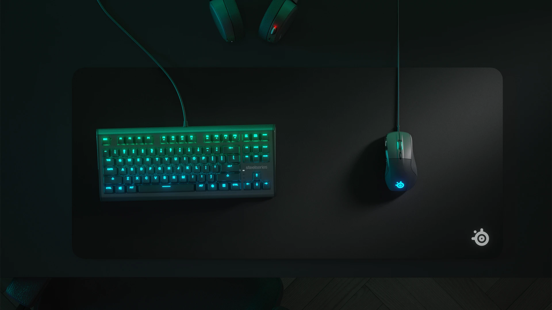 Top view of an RGB keyboard and QcK Heavy mousepad with a mouse; everything in shades of green