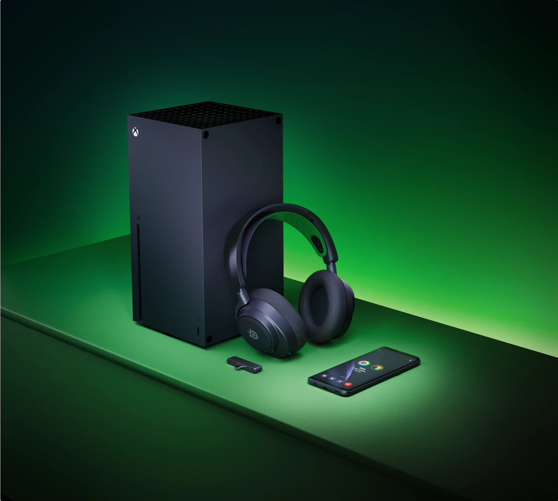 Arctis Nova 5 accompanied by xbox console, a dongle and phone