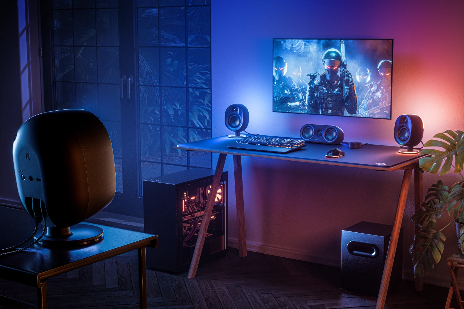 gaming setup in a room illuminated by colorful lights