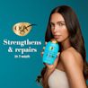 Woman holding Argan Oil of Morocco Shampoo. Strengthens and Repairs in 1 wash