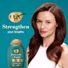 Woman with healthy hair after using ProGrowth + Peptide Conditioner. Strengthen your lengths