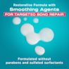 OGX® Bond Protein Repair Pre-shampoo smear on a blue background