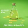 Front shot of a glass laboratory bottle filled with rosemary and mint oil