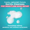  OGX® Bond Protein Repair Shampoo smear on a blue background