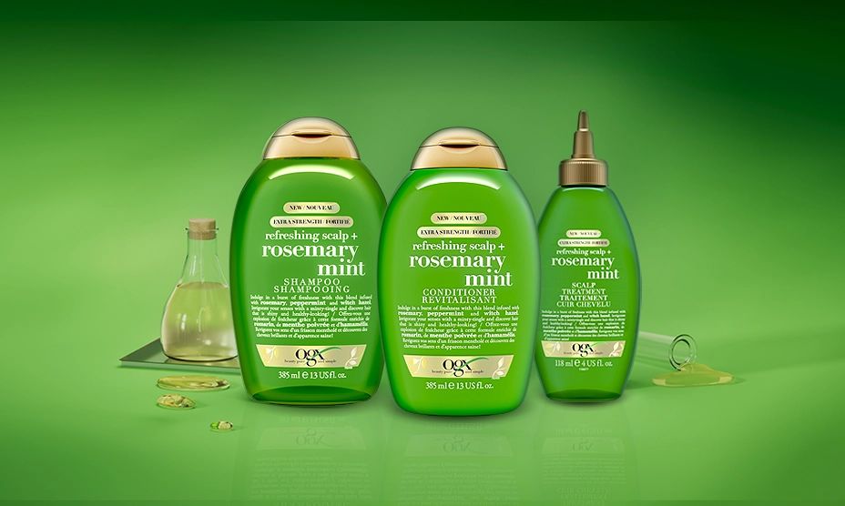 A banner displaying three OGX® Rosemary Mint haircare line with a bottle of peppermint oil 