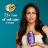 Woman holding Biotin & Collagen Conditioner. 72+ hrs of volume in 1 wash