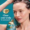 Woman washing hair with ProGrowth + Peptide Shampoo. Clear your scalp for natural growth