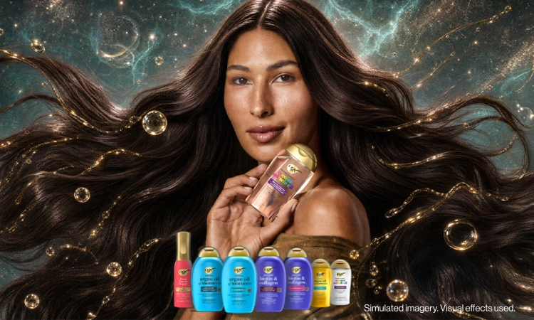 Woman with wavy hair holding a bottle of OGX® Coconut Miracle Oil Penetrating Oil