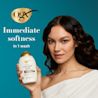 Woman holding Coconut Milk Shampoo. immediate softness in 1 wash