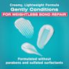 Three OGX® Bond Protein Repair Conditioner product smears on a blue background