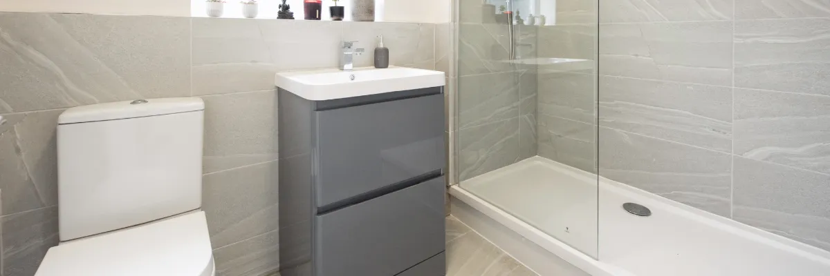 A stylish, modern white and grey bathroom.